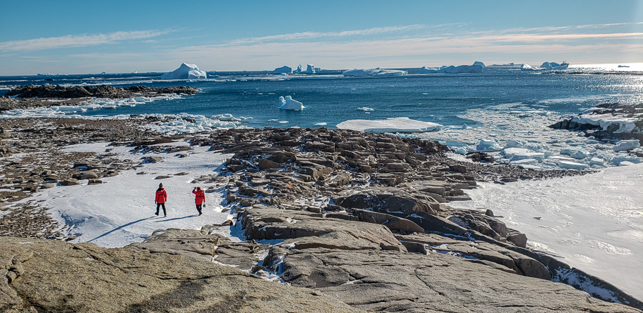 Stunning views of blue water and rocky icy terrain in Antarctica