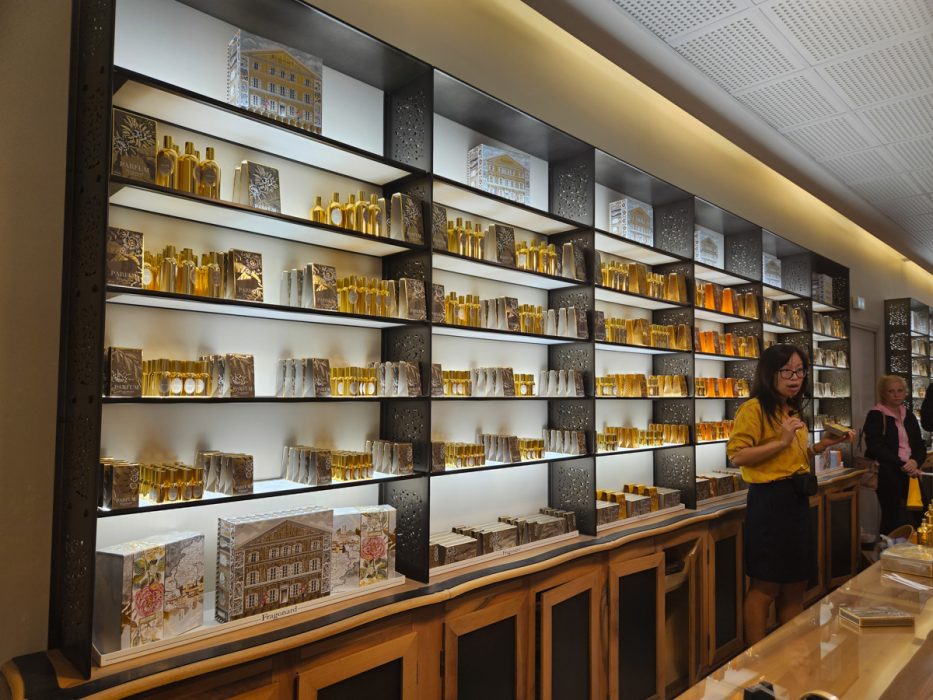 Perfume displayed for sale on shelves